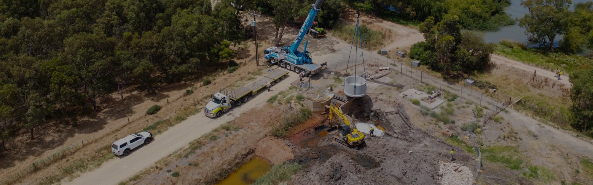 An image of a construction site with trucks